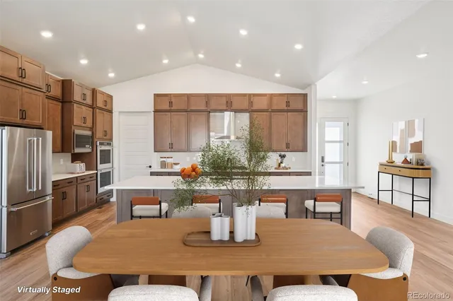a dining room with furniture a window and kitchen view