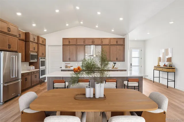 a dining room with furniture a window and kitchen view