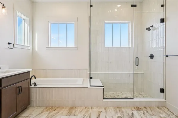 a bathroom with a bathtub and shower