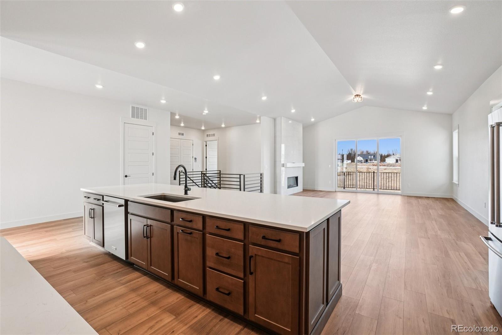 1738 Morningstar Way Fort Collins, CO 80524 - Photo 16 of 47 a large kitchen with stainless steel appliances a large counter top a sink and a refrigerator