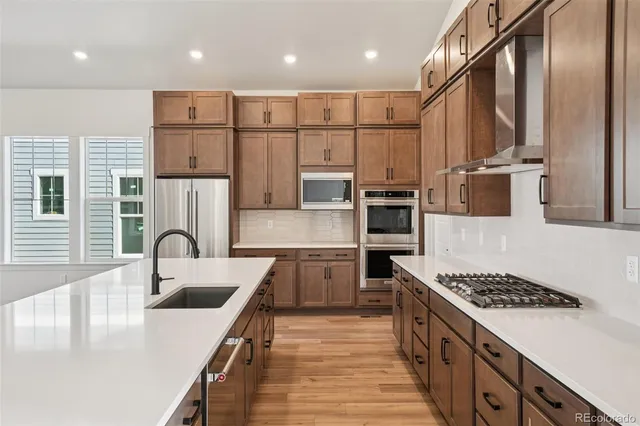 a kitchen with counter top space cabinets and stainless steel appliances