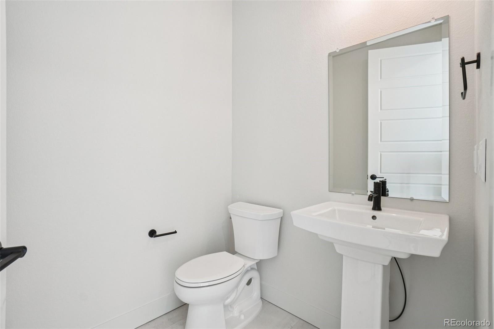 1738 Morningstar Way Fort Collins, CO 80524 - Photo 18 of 47 a bathroom with a sink toilet and a mirror