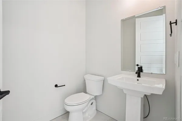 a bathroom with a sink toilet and a mirror