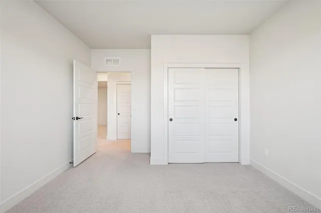 an empty room with closet area