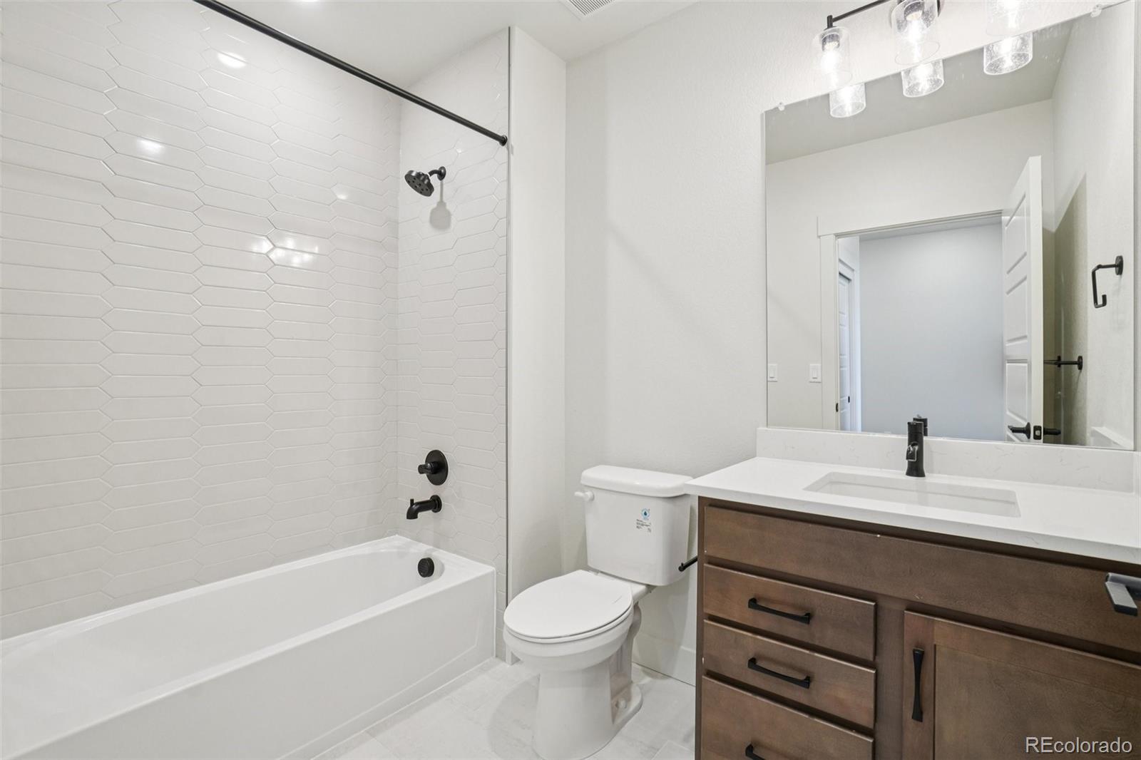1738 Morningstar Way Fort Collins, CO 80524 - Photo 23 of 47 a bathroom with a sink a toilet and a mirror