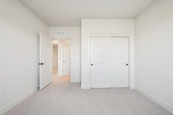 an empty room with closet area