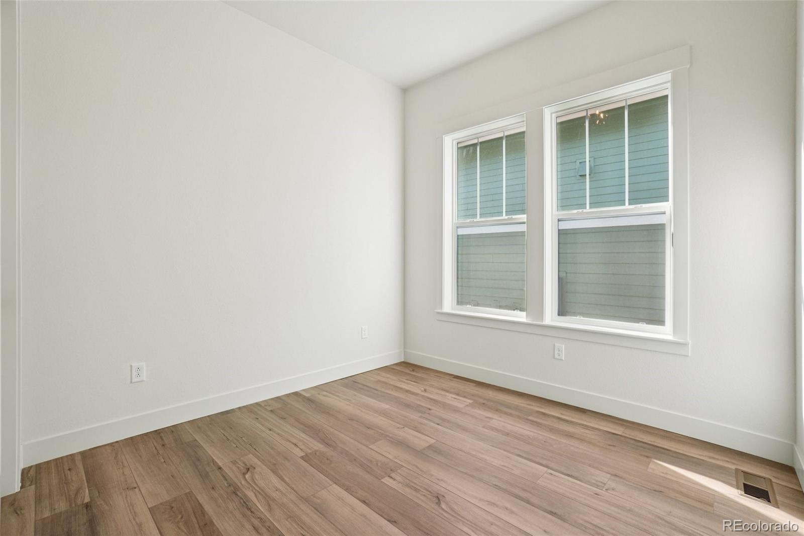 1738 Morningstar Way Fort Collins, CO 80524 - Photo 25 of 47 an empty room with wooden floor and windows