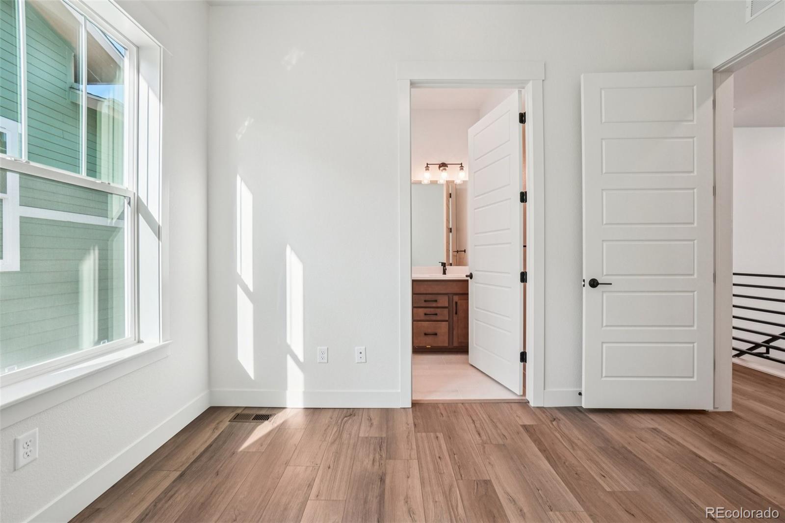 1738 Morningstar Way Fort Collins, CO 80524 - Photo 27 of 47 an empty room with wooden floor and windows