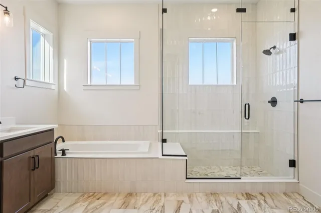a bathroom with a bathtub and shower