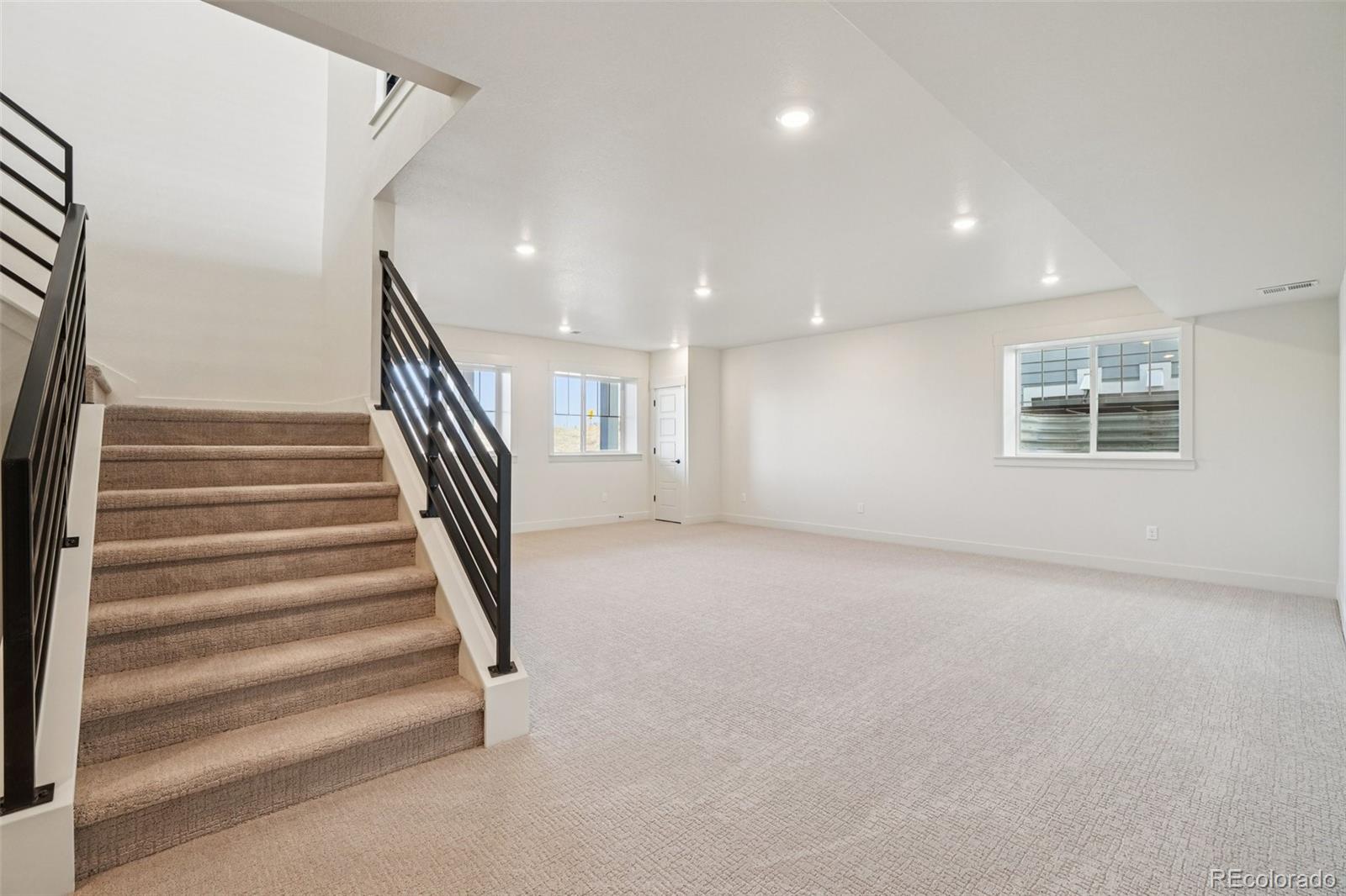 1738 Morningstar Way Fort Collins, CO 80524 - Photo 38 of 47 an empty room with wooden floor and windows