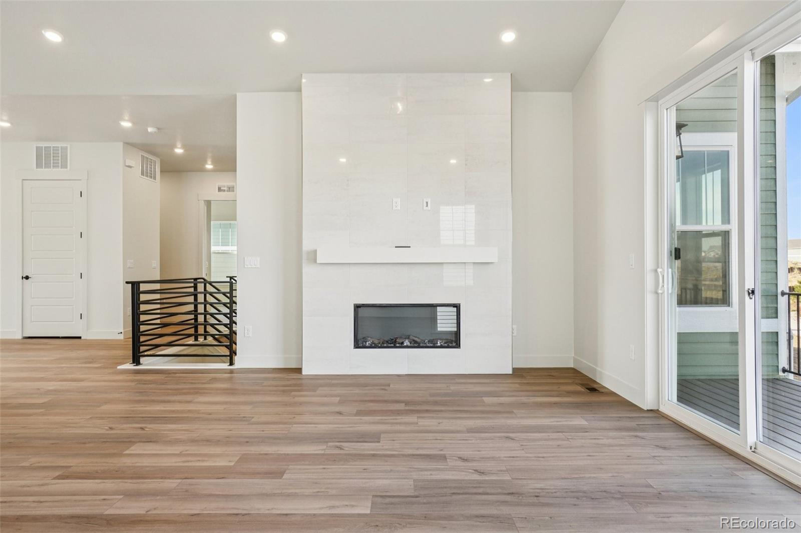 1738 Morningstar Way Fort Collins, CO 80524 - Photo 10 of 47 an empty room with wooden floor and windows
