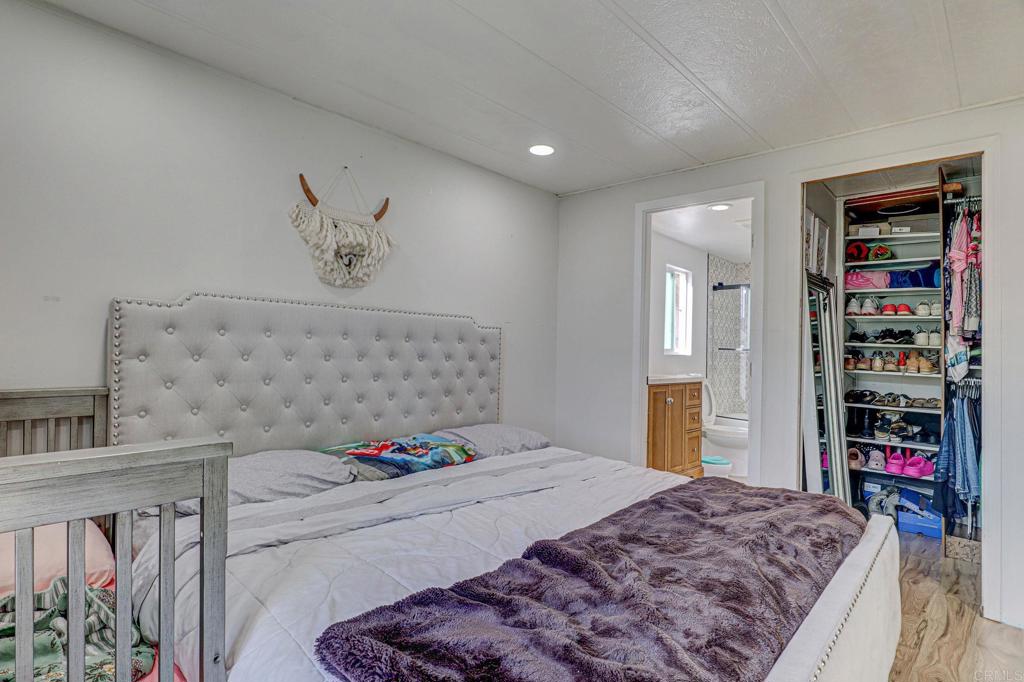 2515 Sweetwater Road, Unit SPC #23 Spring Valley, CA 91977 - Photo 13 of 21 a bedroom with bed and walk in closet