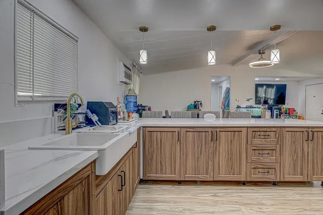 a kitchen with a sink cabinets appliances and a window