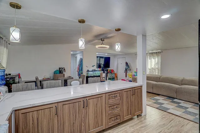 a bathroom with a granite countertop sink and a large mirror