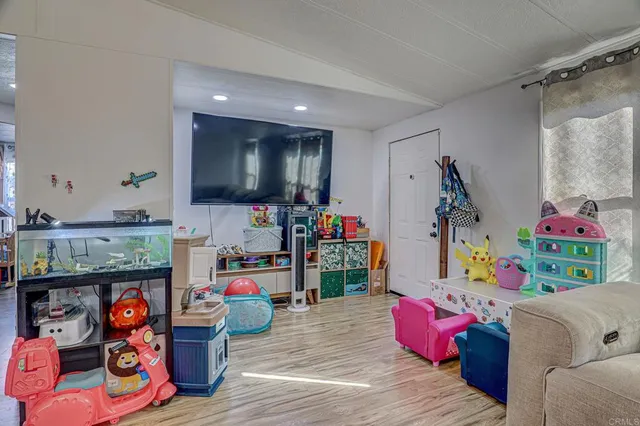 a living room with furniture and a play room