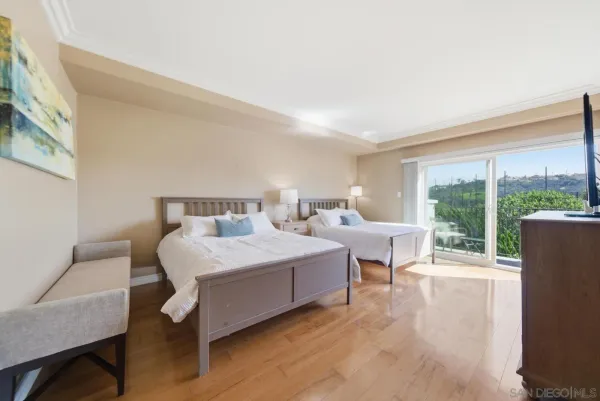 a bedroom with a bed and a large window