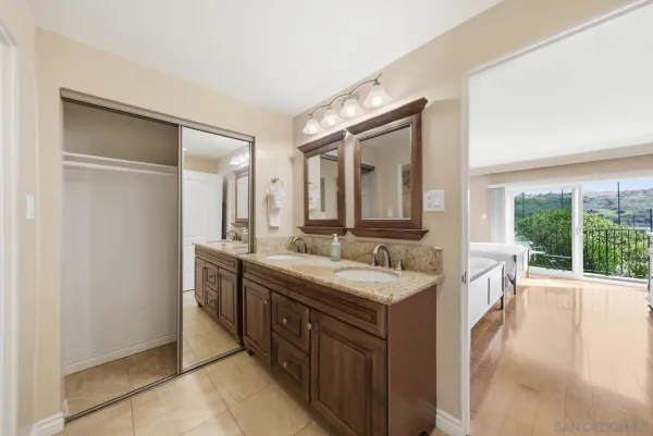 a spacious bathroom with a double vanity sink and a mirror