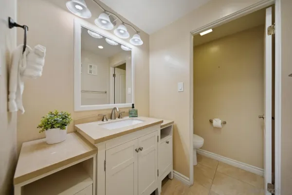 a bathroom with a sink vanity and a mirror