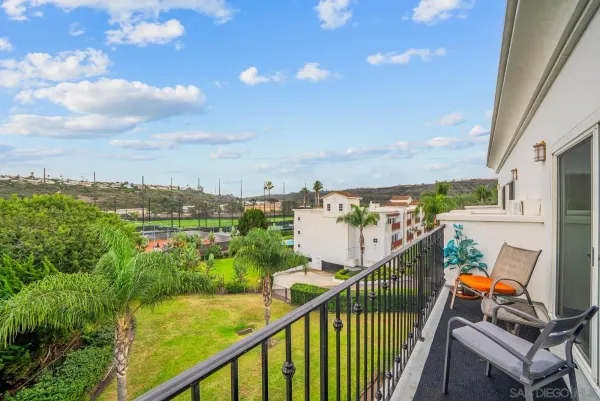a view of a balcony with an outdoor seating