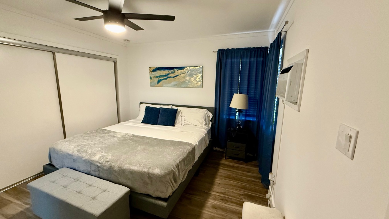 1802 East University Avenue, Unit B Georgetown, TX 78626 - Photo 11 of 12 a bedroom with a bed and a mirror