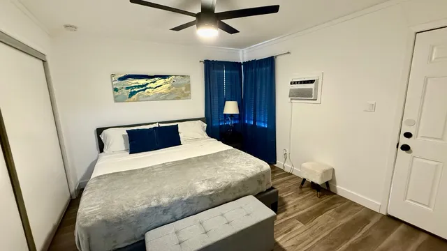 a bedroom with a bed and wooden floor