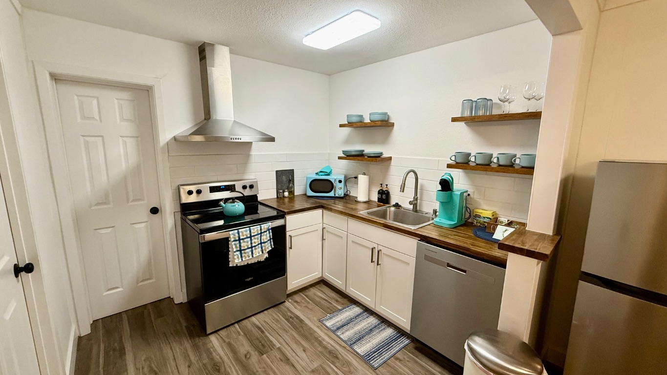 1802 East University Avenue, Unit B Georgetown, TX 78626 - Photo 8 of 12 a kitchen with stainless steel appliances a stove a sink a refrigerator and cabinets