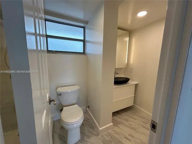a bathroom with a shower and a toilet
