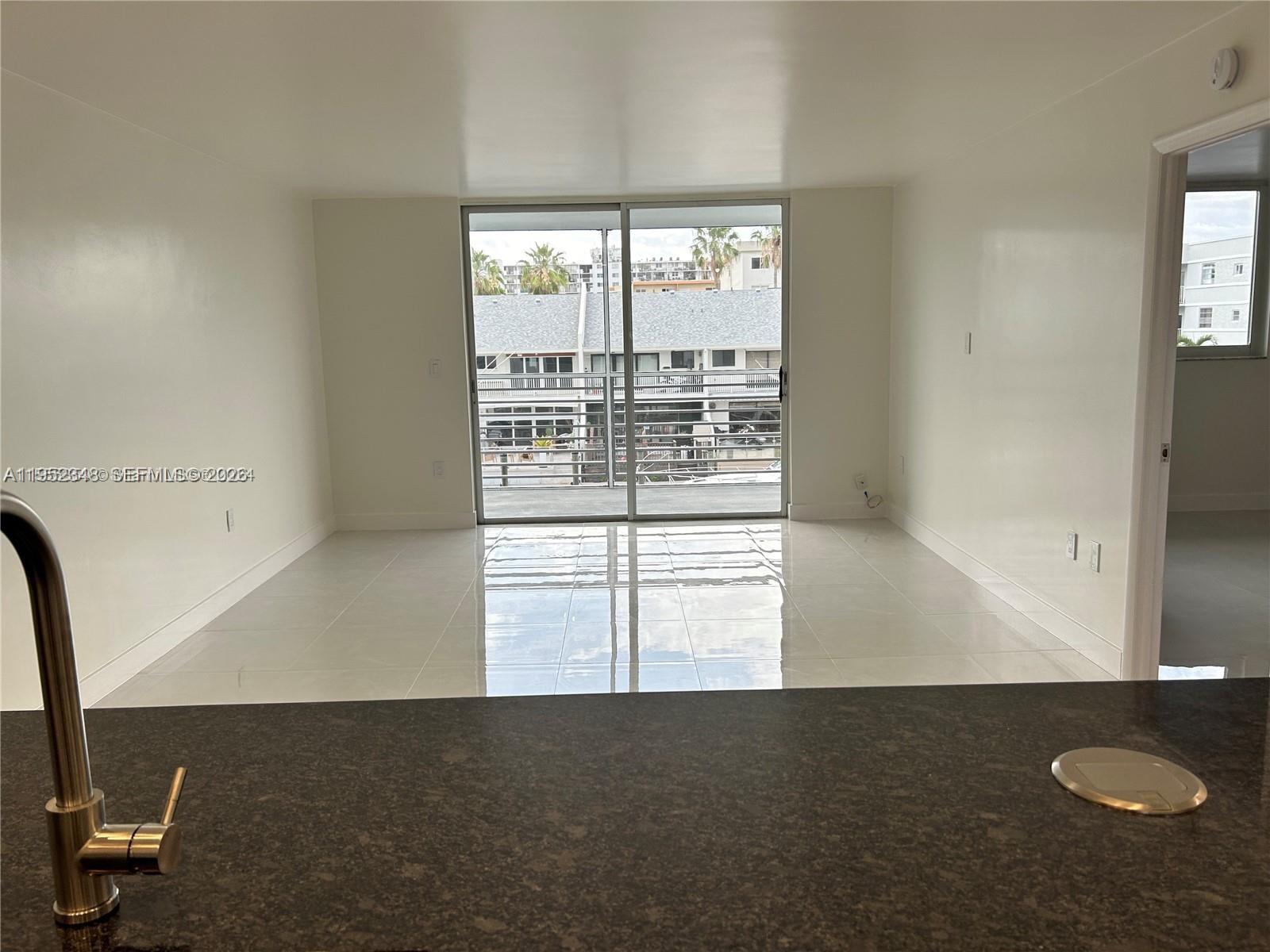 3550 Northeast 169th Street, Unit 304 North Miami Beach, FL 33160 - Photo 20 of 25 an empty room with windows