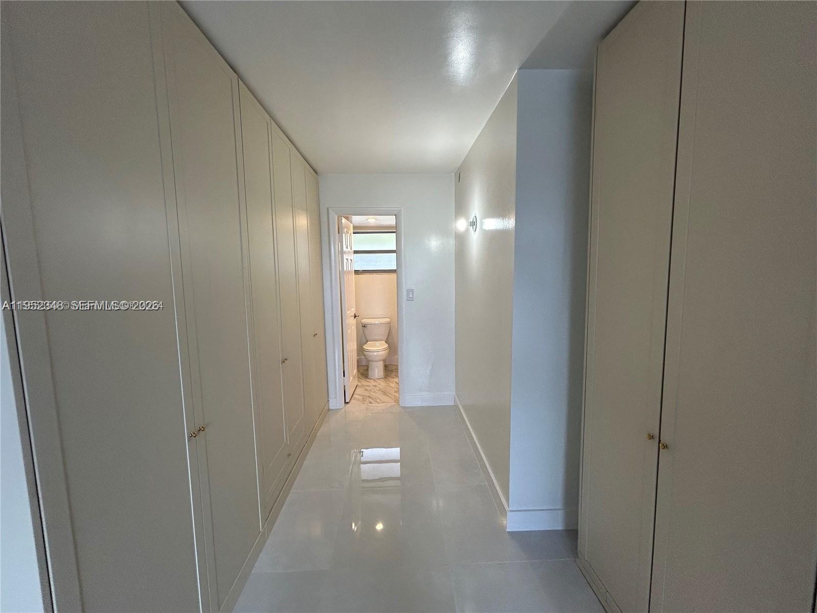 3550 Northeast 169th Street, Unit 304 North Miami Beach, FL 33160 - Photo 6 of 25 a view of hallway with closet