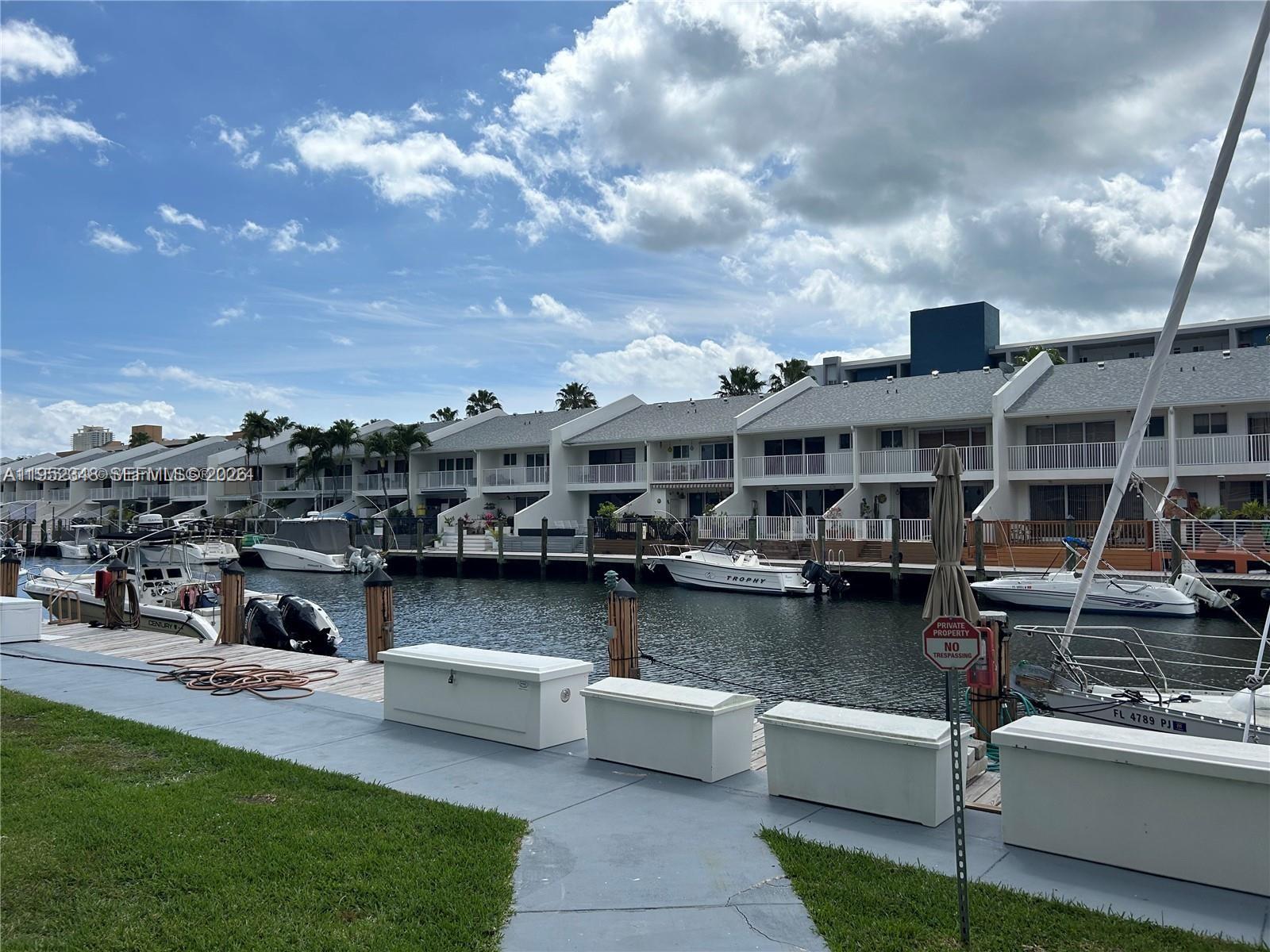 3550 Northeast 169th Street, Unit 304 North Miami Beach, FL 33160 - Photo 8 of 25 a view of a lake with couches chairs and a table