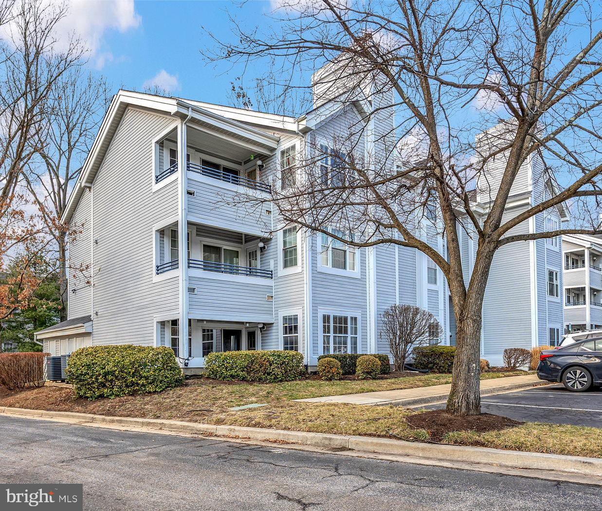 604 Moonglow Road, Unit 104 Odenton, MD 21113 - Photo 18 of 19 a front view of residential houses with yard and trees