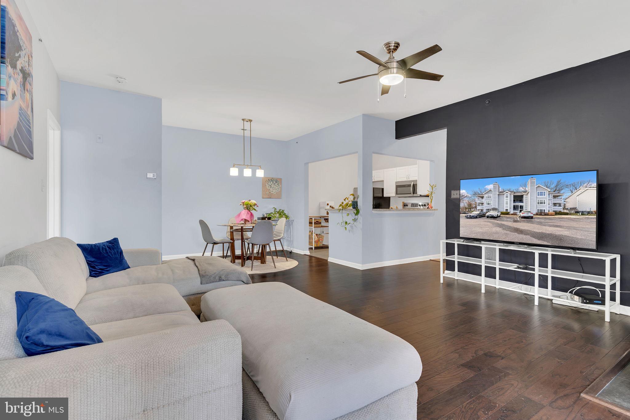 604 Moonglow Road, Unit 104 Odenton, MD 21113 - Photo 4 of 19 a living room with furniture and kitchen view