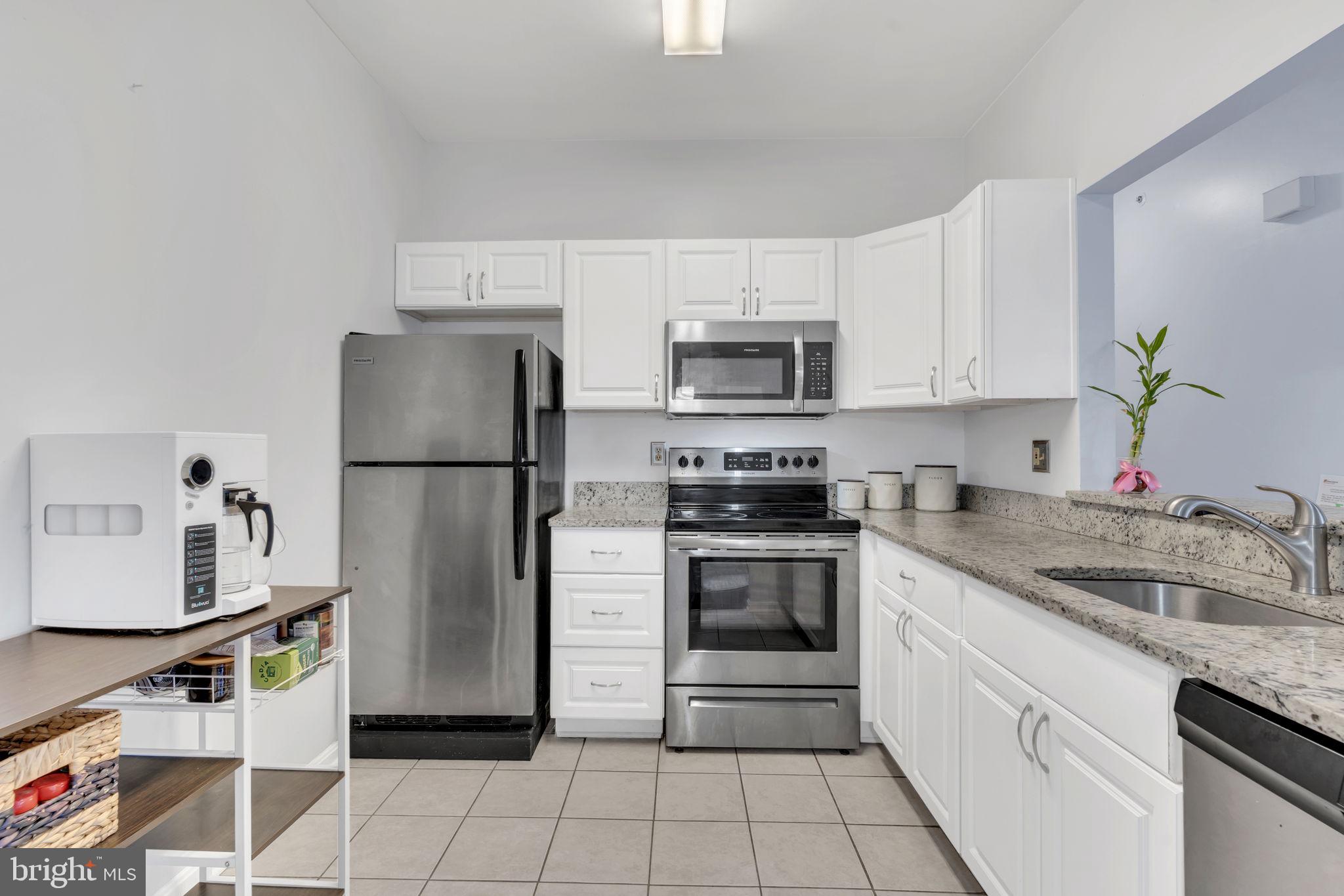 604 Moonglow Road, Unit 104 Odenton, MD 21113 - Photo 8 of 19 a kitchen with a sink appliances and cabinets