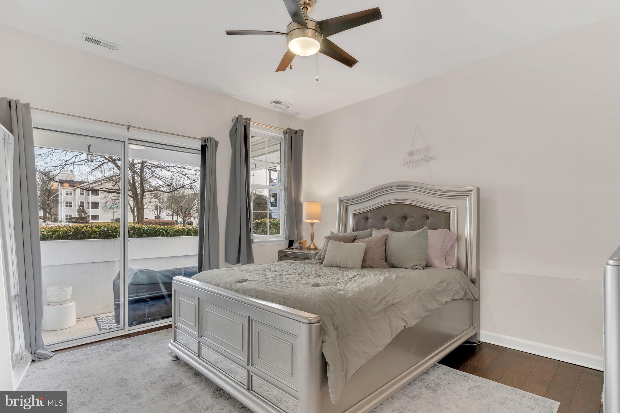 604 Moonglow Road, Unit 104 Odenton, MD 21113 - Photo 10 of 19 a bedroom with a large bed and a large window