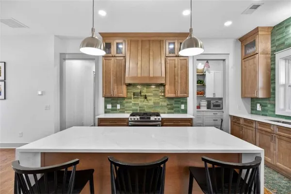 a kitchen with a stove and a white cabinet