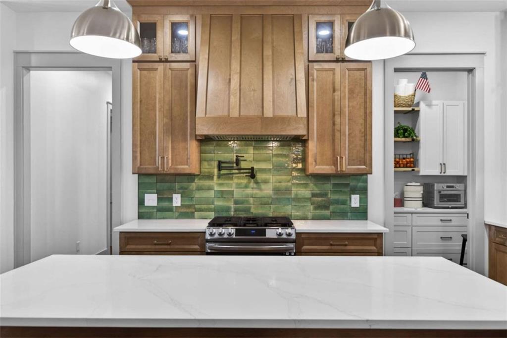 433 Old Roanoke Road Bowdon, GA 30108 - Photo 13 of 52 a kitchen with a stove and a white cabinet
