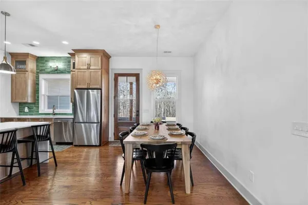 a kitchen with a refrigerator and cabinets
