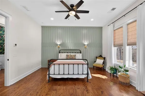 a bedroom with a bed and wooden floor
