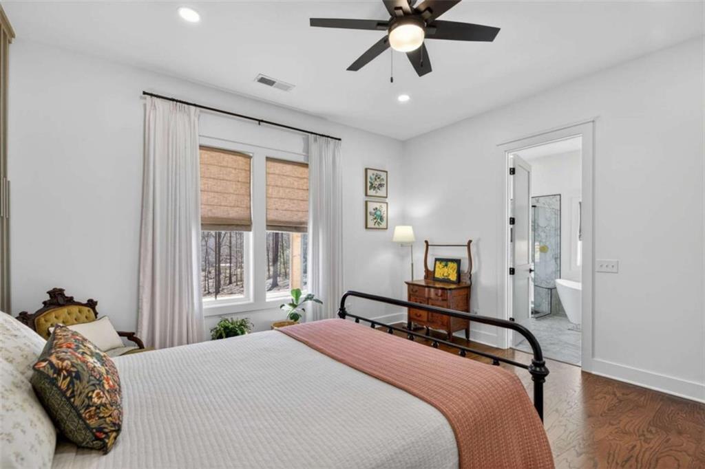 433 Old Roanoke Road Bowdon, GA 30108 - Photo 24 of 52 a bedroom with a bed and wooden floor