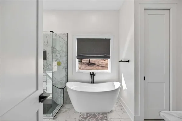a bathroom with a granite countertop sink mirror and a shower
