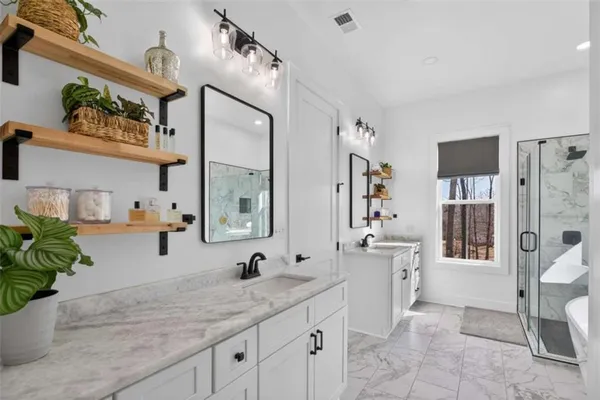 a bathroom with a shower sink and mirror