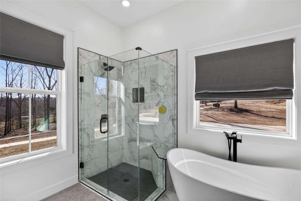 433 Old Roanoke Road Bowdon, GA 30108 - Photo 28 of 52 a bathroom with a shower sink and mirror