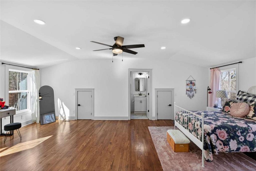 433 Old Roanoke Road Bowdon, GA 30108 - Photo 33 of 52 a bedroom with a bed and a chandelier