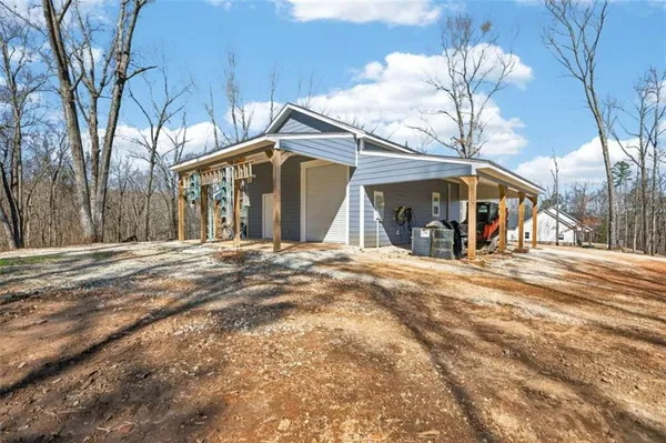 a view of a house with a yard and trees