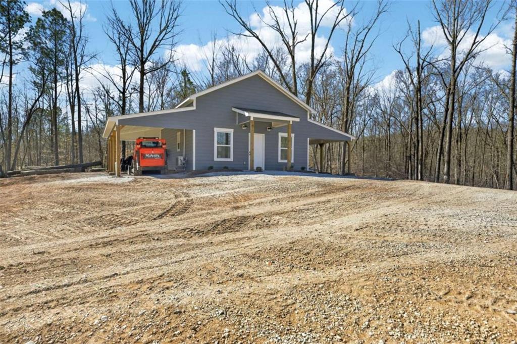 433 Old Roanoke Road Bowdon, GA 30108 - Photo 42 of 52 a view of a house with a yard and trees