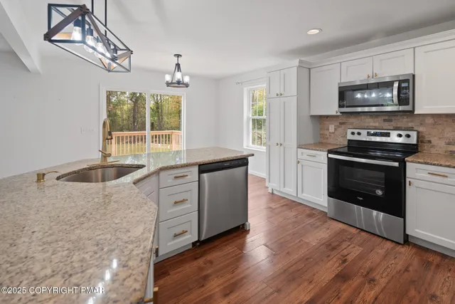 a kitchen with wooden cabinets and stainless steel appliances