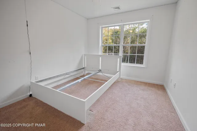 a room with pool table and windows