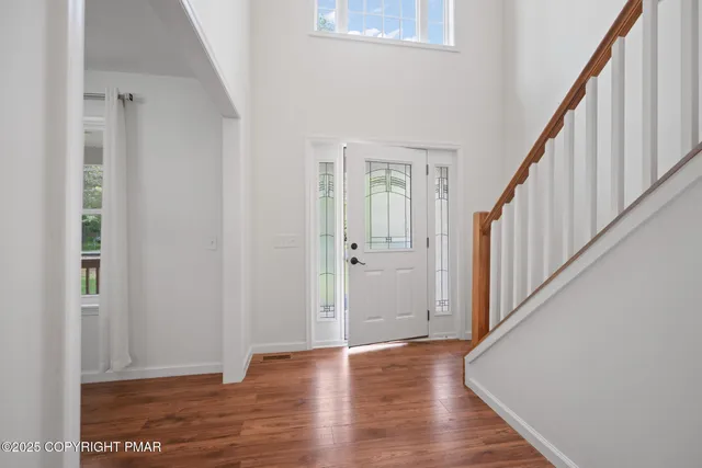 a view of an entryway with wooden floor