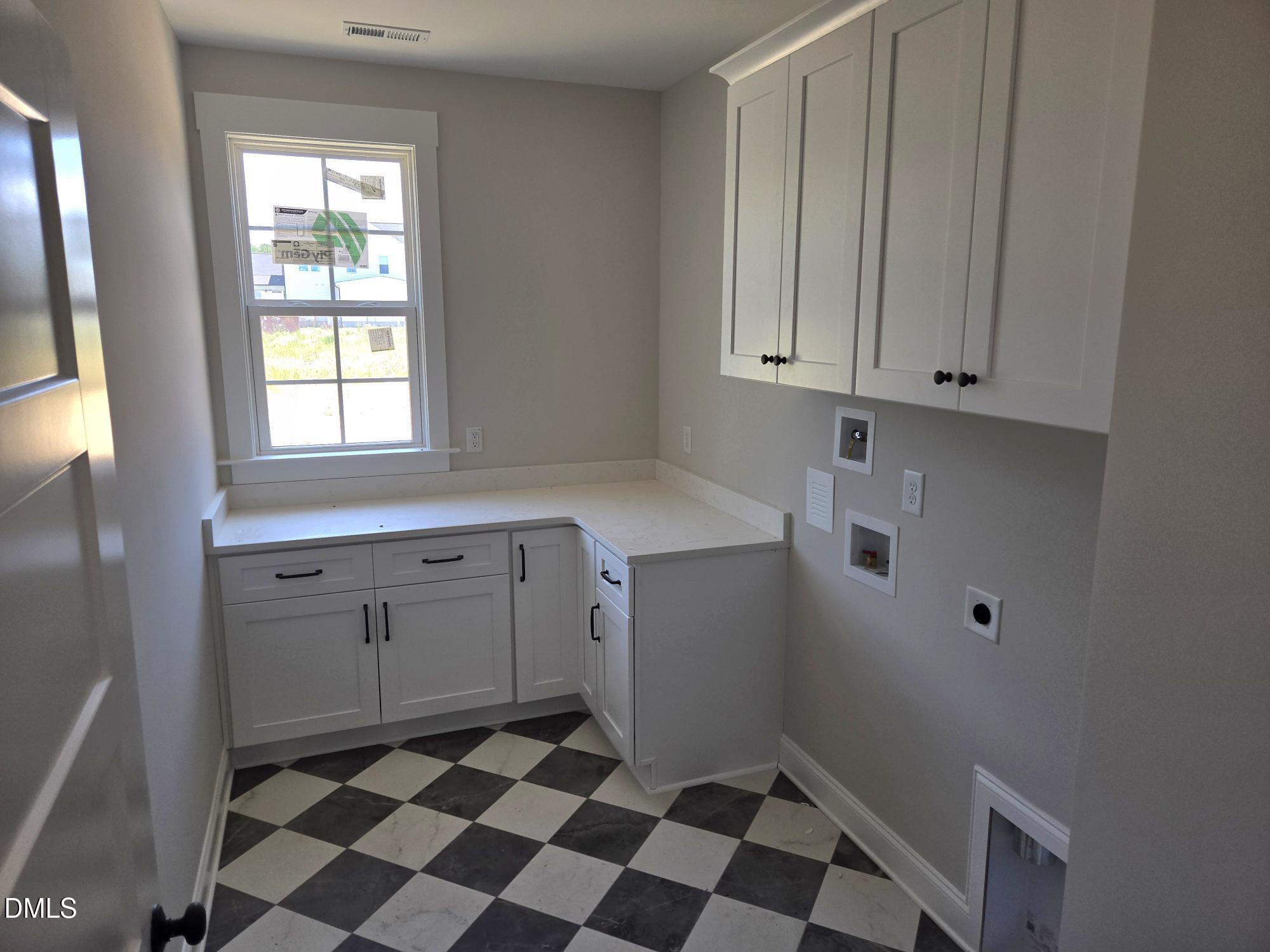 300 Avery Road Erwin, NC 28339 - Photo 10 of 38 a room with white cabinets and black appliances