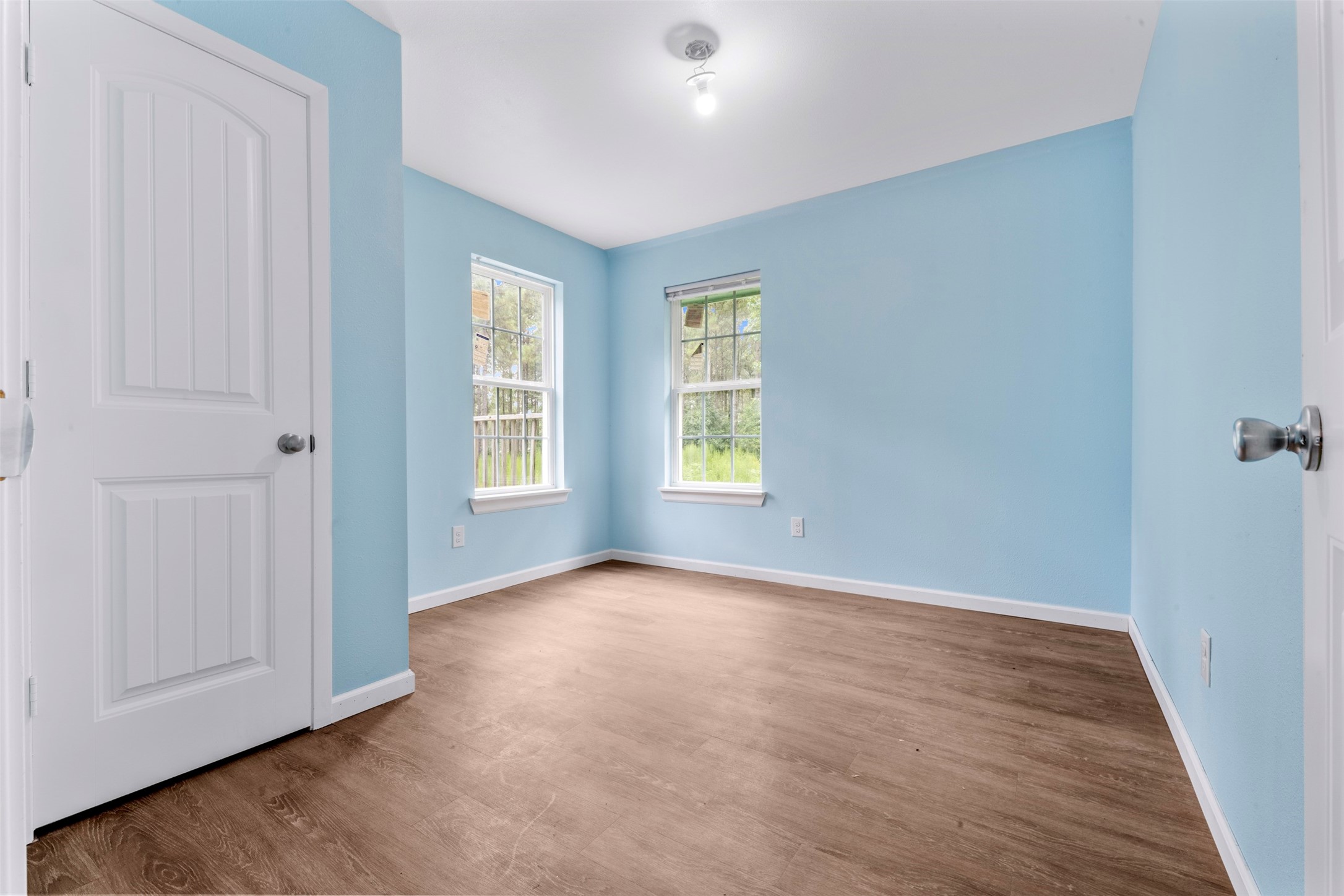 235 Bracewell Cemetery Road Livingston, TX 77351 - Photo 19 of 39 an empty room with wooden floor and windows
